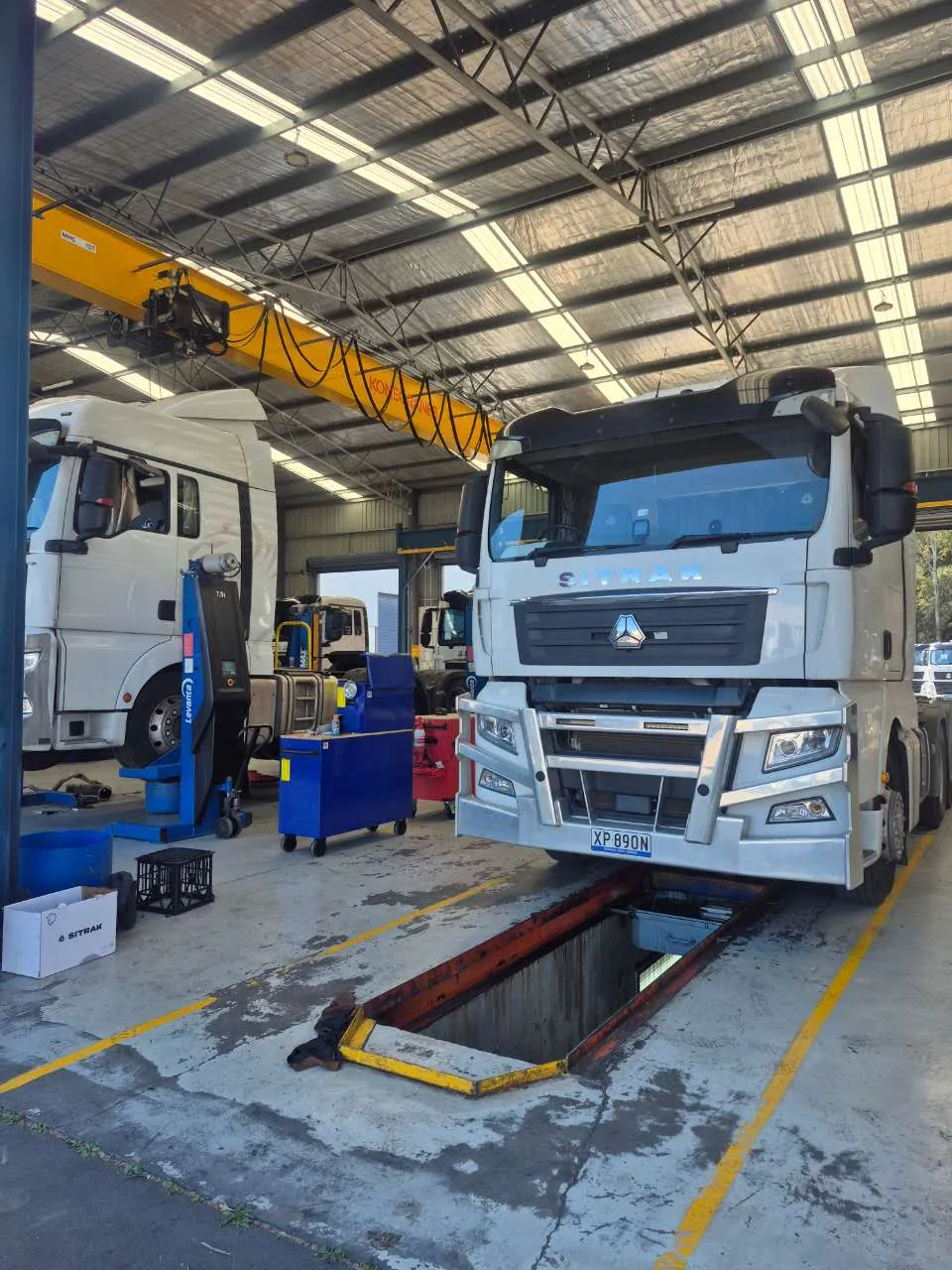 Two SITRAK trucks in the RUMBLE Auto service workshop